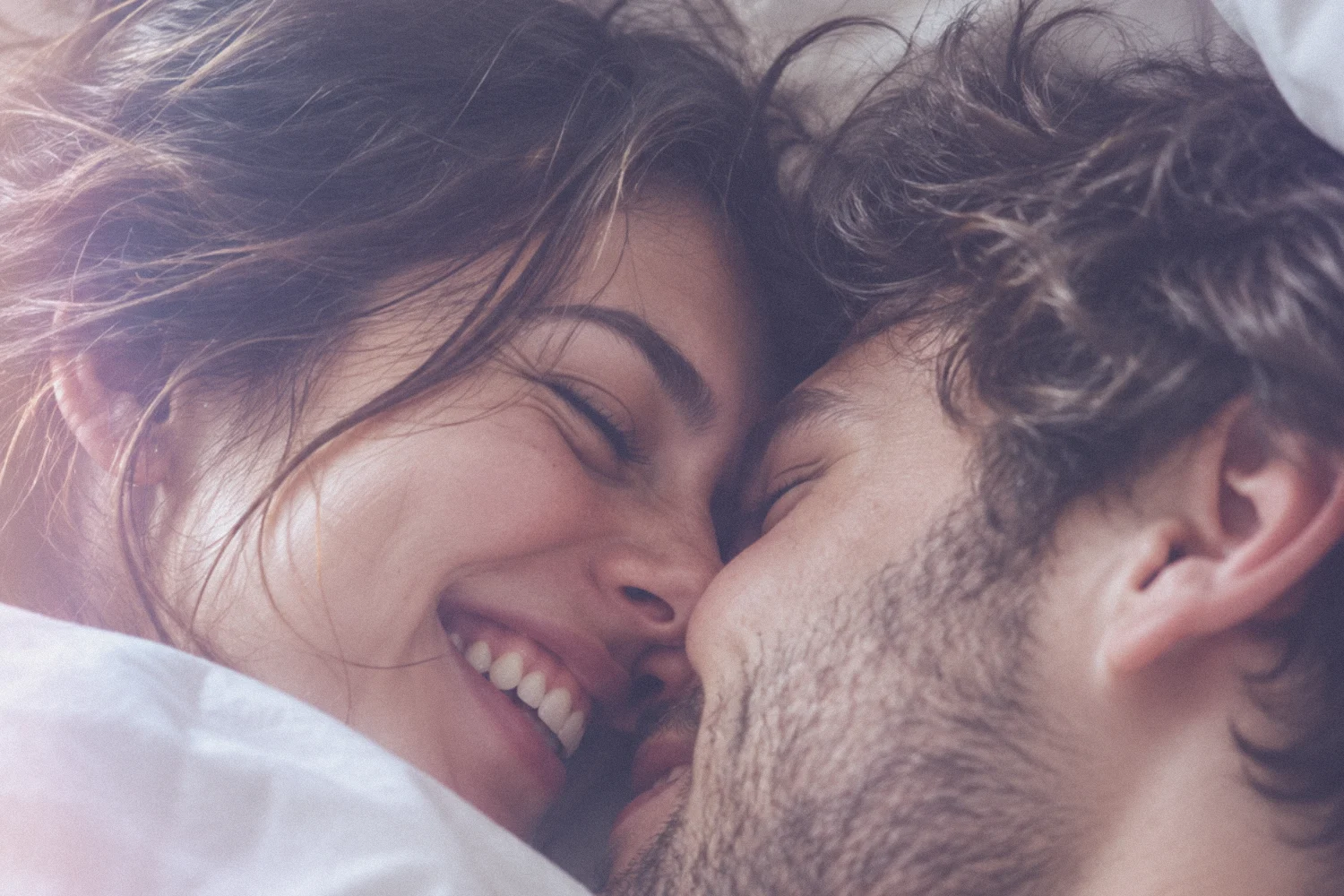 A couple relaxed and close together in bed